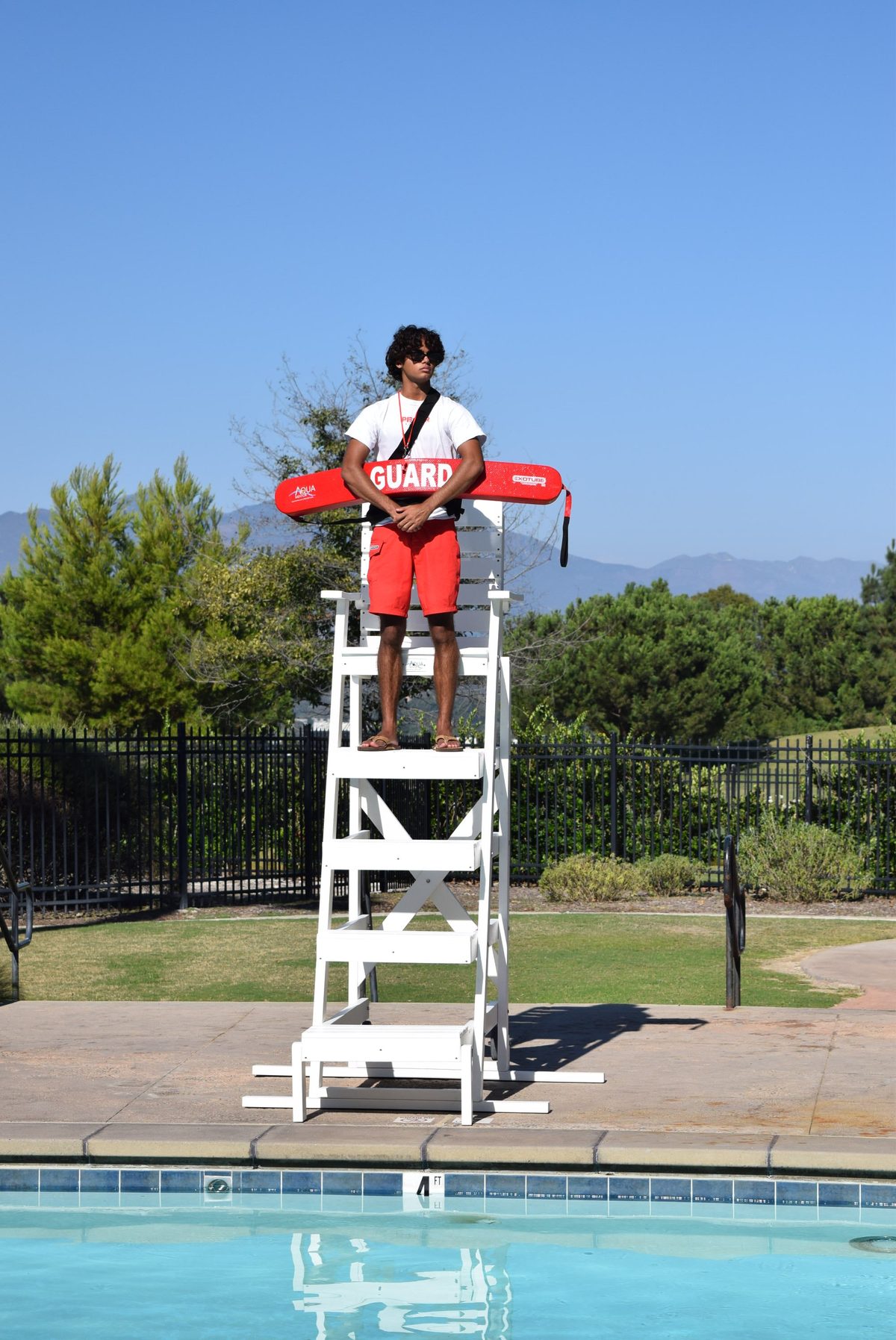 Lifeguard with rescue tube on patrol